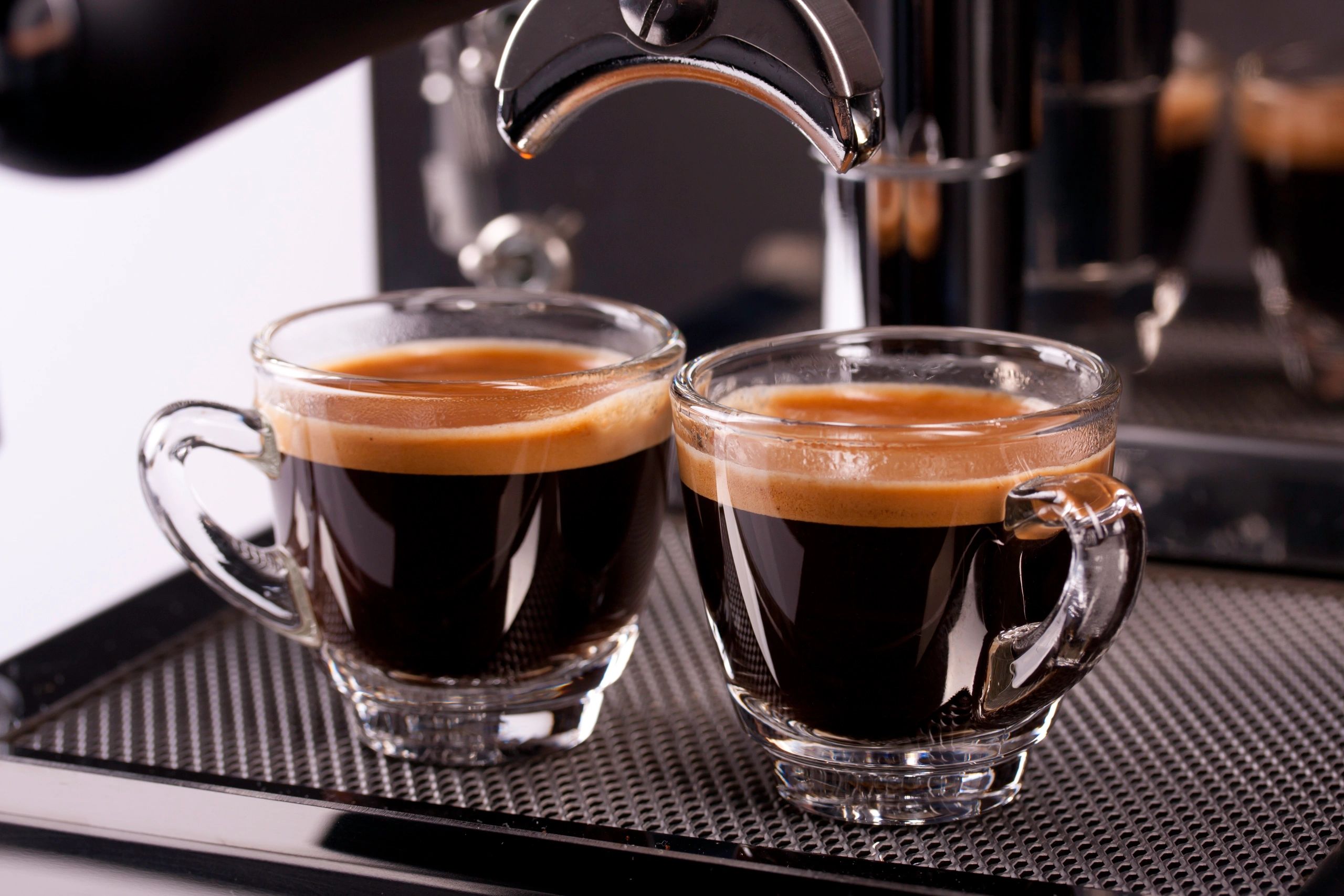 Two cups of espresso with crema