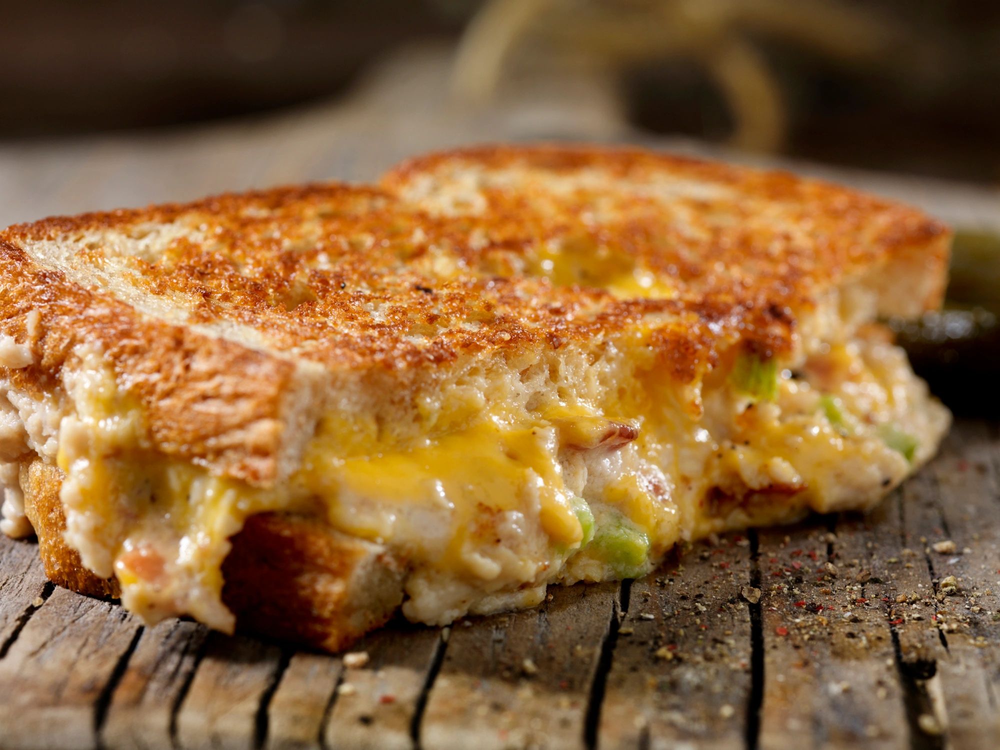Toasted grilled cheese sandwich served on a wooden board