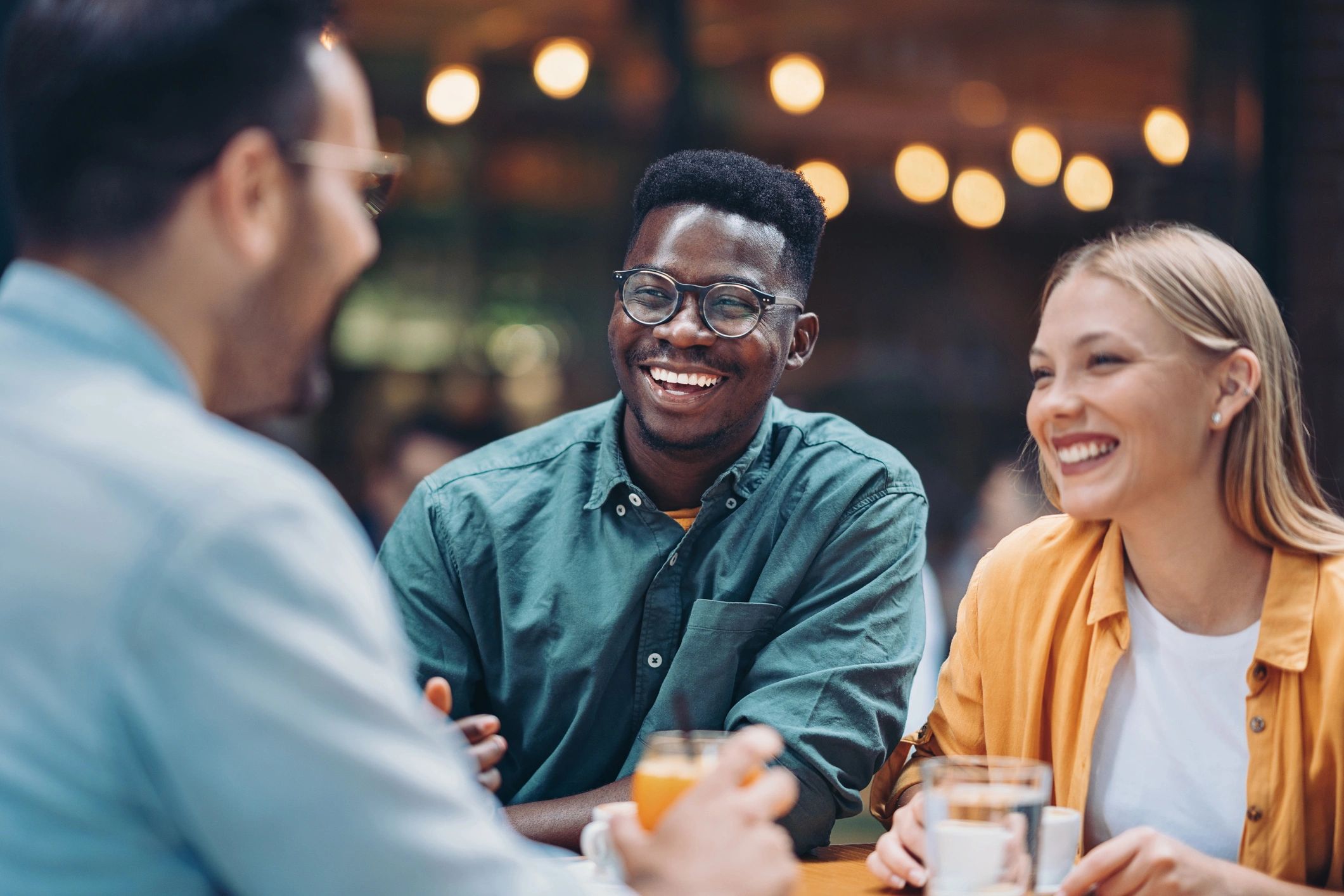 Friends enjoying drinks together in a cafe