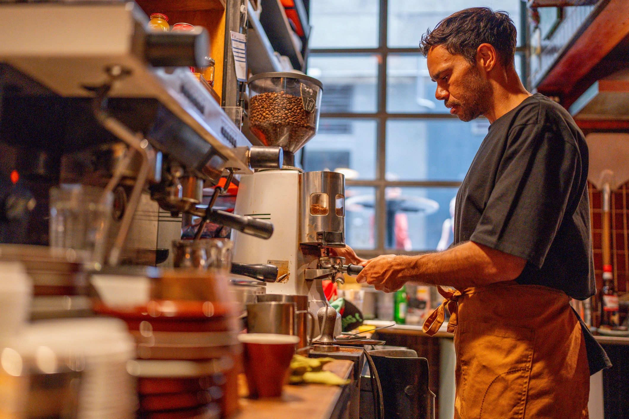 Barista preparing espresso at a cafe counter