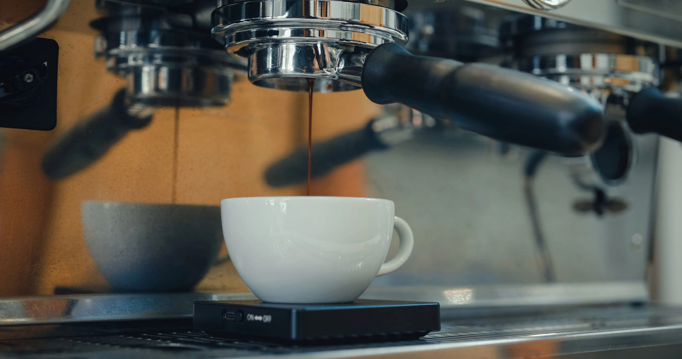 Espresso machine brewing coffee into a cup