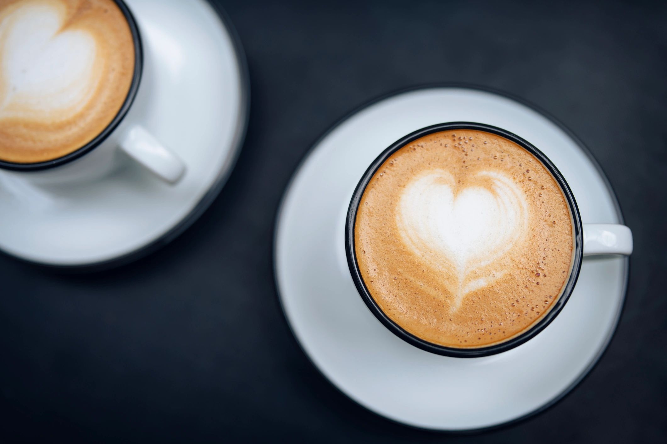 Two cups of cappuccino with heart shaped latte art