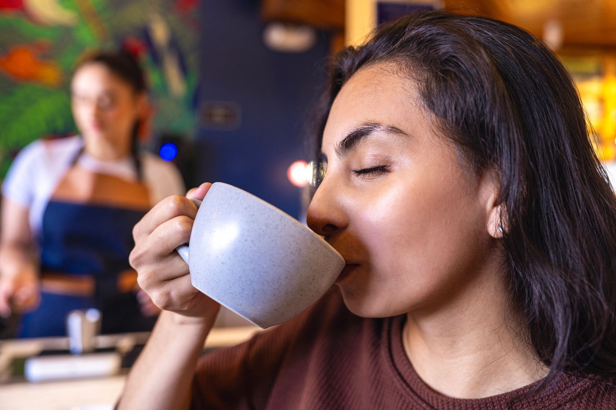 Customer enjoying coffee in a cafe setting