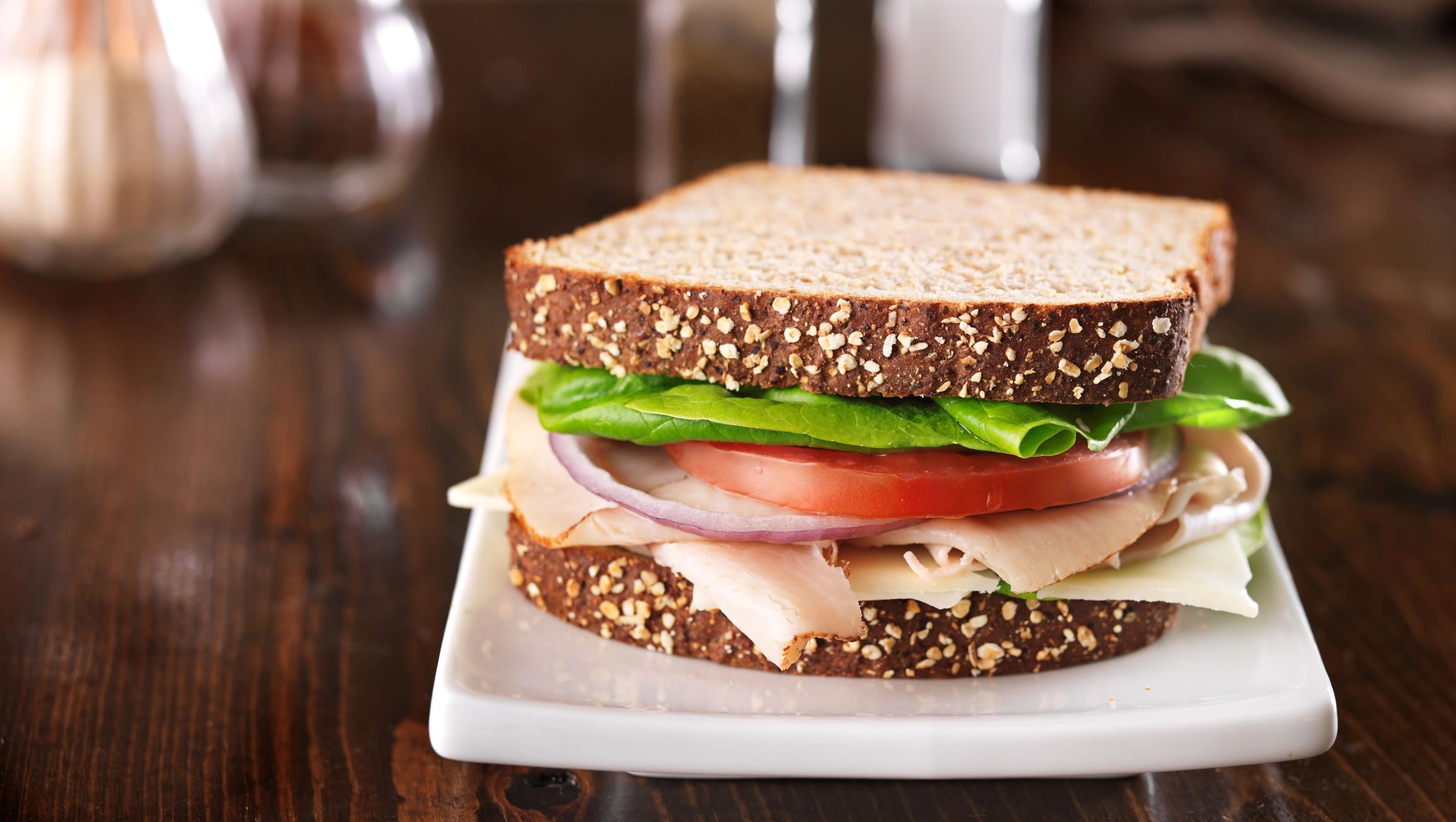 Deli meat sandwich on a board with copy space